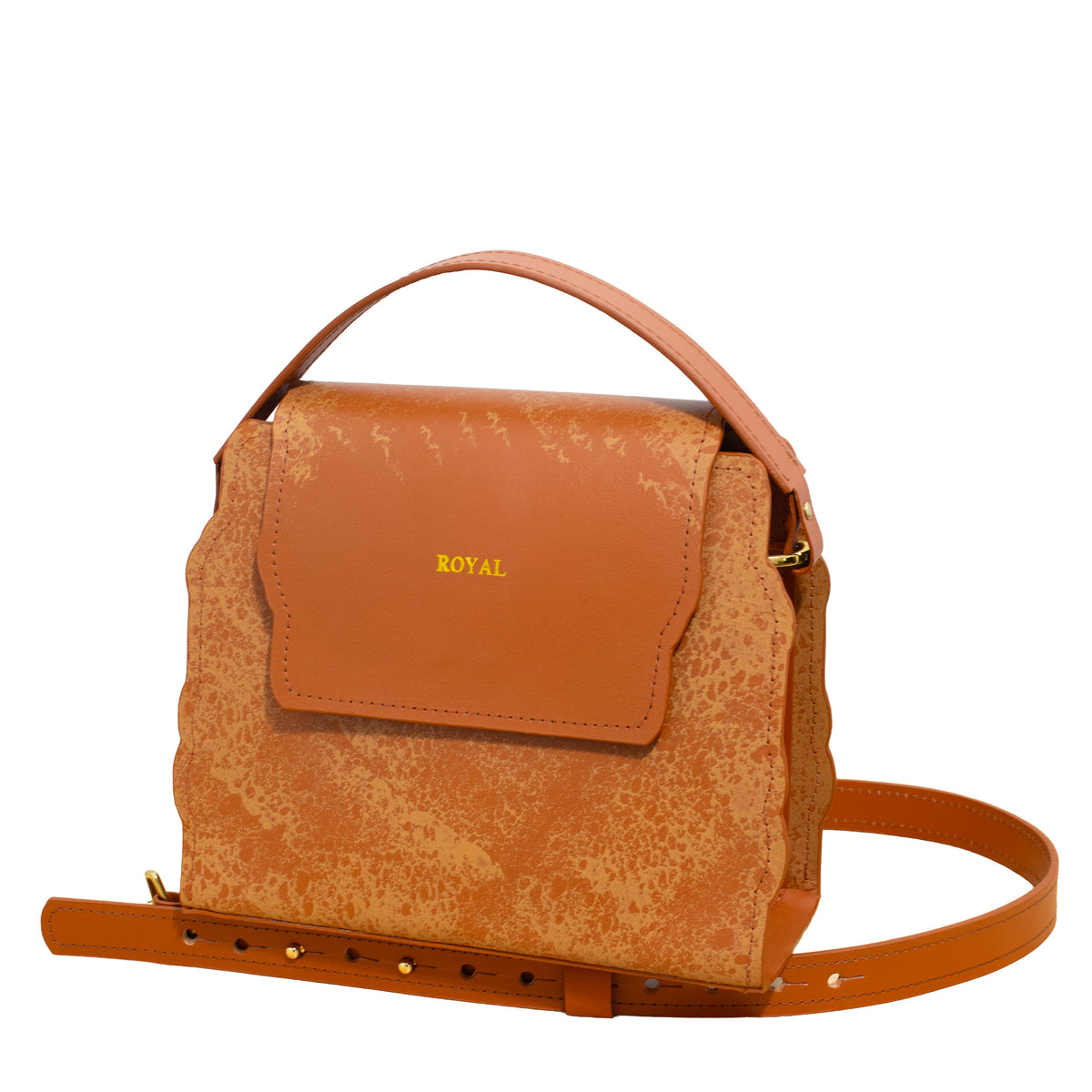Close‑up of hand‑painted cognac multi‑tone full‑grain vegetable‑tanned leather on the Hope handbag with its removable strap