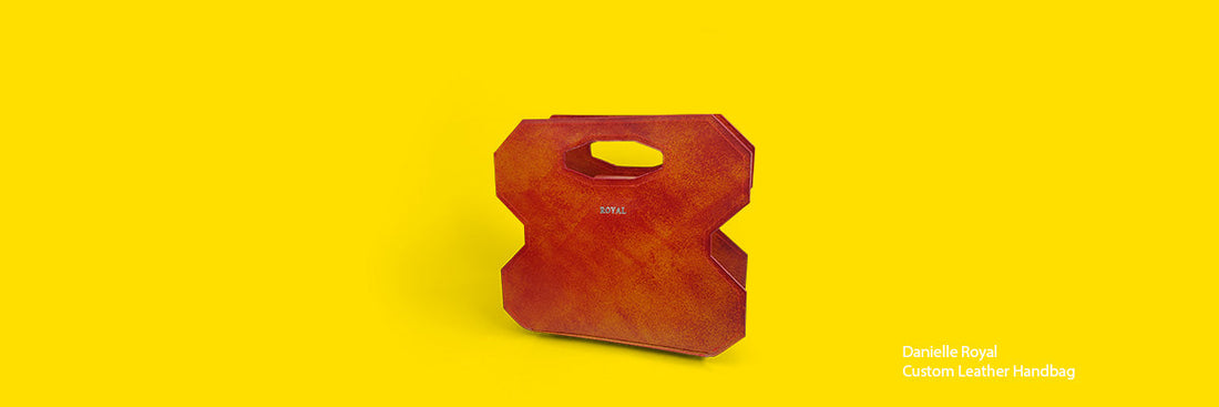 Hand‑painted full‑grain leather handbag showing its structured silhouette and color details.