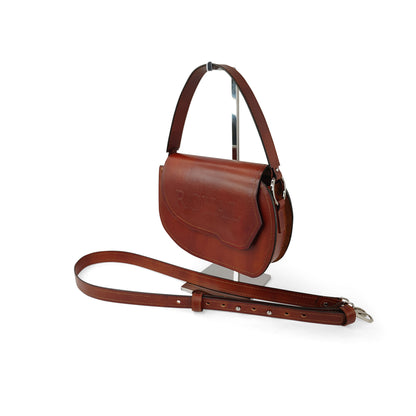 Hand‑painted full‑grain leather Grace top‑handle crossbody bag handcrafted in brown, shown in a side view highlighting the top handle and strap.  