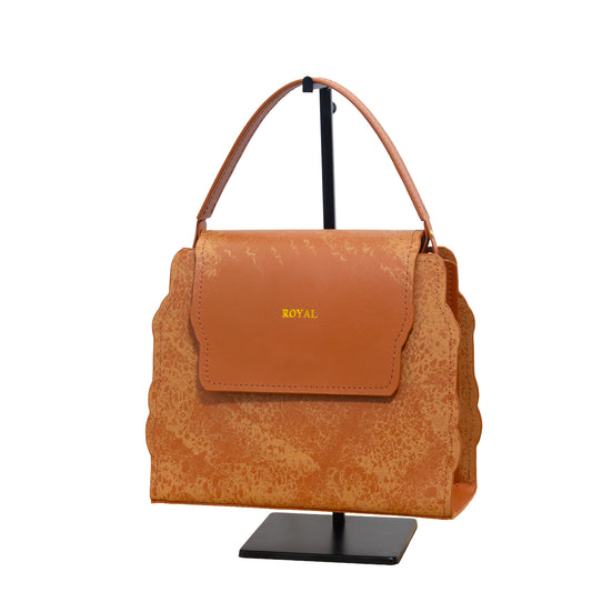 Hope hand‑painted leather satchel in cognac artisan multi‑tone with a handcrafted structured silhouette and a refined top handle on a stand.