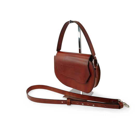 Hand‑painted full‑grain leather Grace top‑handle crossbody bag handcrafted in brown, shown closed on a stand with its structured silhouette.  